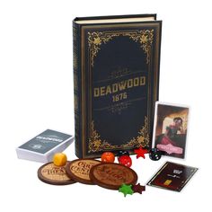 the deadwood book and its contents are shown in front of an open card case