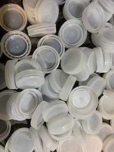 a pile of white plastic plates and bowls