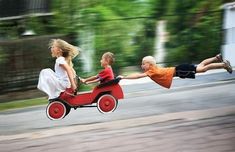 two children riding on a toy car with an advertise for the movie,'at some point in your childhood, you and your friends went outside to play together for the last time, and nobody knew