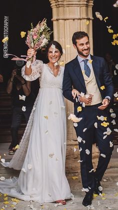 a newly married couple walking through confetti