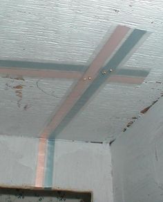 an unfinished ceiling with some paint on it