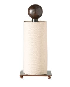 a toilet paper holder with a wooden ball on top