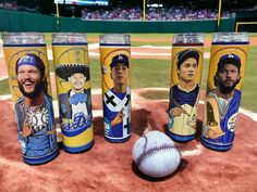 the cups have pictures of baseball players on them, along with a ball in the outfield