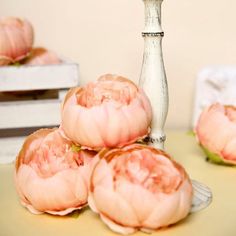 some pink flowers are sitting on a table