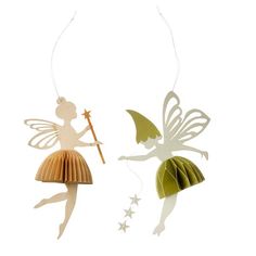 two paper fairy ornaments hanging from strings on a white background, one with a wand and the other with stars