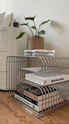 a stack of books sitting on top of a metal shelf