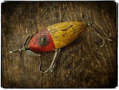 an old fishing lure sitting on top of a wooden table