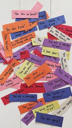 many colorful pieces of paper with words written on them