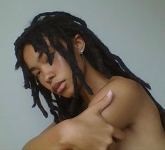 a close up of a person with dreadlocks on their head and one arm