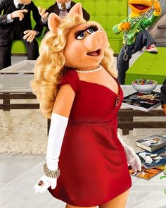 the muppets are dressed in red dresses and white gloves, standing next to each other