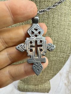 Vintage Ethiopian Coptic Christian Cross Silver Pendant From Ethiopia, Africa.This antique silver pendant on a 20" chain features a Coptic Christian cross, handcrafted by Ethiopian Metalsmiths. The pendant is made of ethnic silver and has a beautiful silver color. It is an original piece from Ethiopia, Africa, and is perfect for collectors of African ethnographic jewelry. The pendant is a unique and rare find, and would make a great addition to any jewelry collection. SKU 860 Ethiopian Coptic Cross, Ethiopian Royalty, Coptic Cross, African Style, Christian Cross, Ethiopia, Halloween Shopping, Silver Pendant, Silver Color