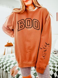 Get into the spooky season spirit with our Boo Sweatshirt, a cozy Halloween crewneck featuring varsity letter designs and a playful bat sleeve print. ABOUT THE SWEATSHIRT Comfort Colors 1466 100% ring-spun cotton Light fabric  OEKO-TEX certified low-impact dyes Relaxed Fit  Size up 1-2 sizes for oversized fit SHIPPING AND PROCESSING All sweatshirts are processed and shipped within 1-7 business days from purchase.  RETURN POLICY We want you to be happy with your purchase! if you need to request a Orange Letter Print Crew Neck Hoodie, Oversized Halloween Hoodie With Letter Print, Oversized Hoodie With Letter Print For Halloween, Fall College Hoodie With Letter Print, College Letter Print Hoodie For Fall, Letter Print Hoodie For College In Fall, Fall Game Day Sweatshirt With Letter Print, Varsity Hoodie Sweatshirt For Fall, Letter Print Sweatshirt For Game Day In Fall