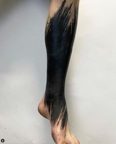 a person's leg with black paint on it