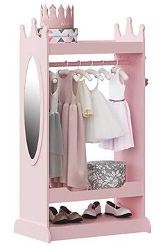 a pink closet with clothes and shoes hanging on the rack, next to a mirror