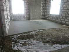 an unfinished room with two windows and no insulation on the floor in front of it