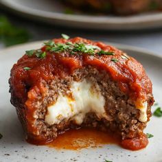 meatloaf stuffed with cheese and sauce on a plate