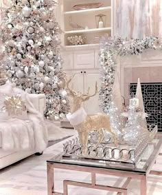 a living room filled with white furniture and a christmas tree in the middle of it