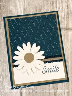 a close up of a card with a white flower on the front and blue background