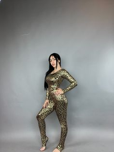 Gold Catsuit - Stunning Costume Bodysuit!Description:Elevate your style with our Gold Cheetah print Catsuit, perfect as a costume for gymnast, dancers, festival fashion and active wear.Features:Long sleeves and a flattering scoop neck for a sleek look.Designed to fit like a glove, offering both softness and firmness for maximum comfort.Fabric Quality:Prepare to be amazed by the brilliance of this fabric! Its shiny finish not only flatters but also enhances your curves effortlessly.Whether you're Stretch Dancewear Bodysuit For Costume Party, Fitted Leopard Print Bodysuit For Party, Spandex Catsuit, Costume Bodysuit, Catsuit Costume, Festival Mode, Bodysuit Costume, Exotic Dance, Stilts