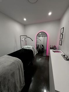 a bed room with two beds and a mirror on the wall next to each other