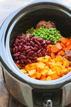 the food in the crock pot is mixed with beans and carrots to make a healthy meal