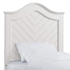 a white headboard with two pillows on it