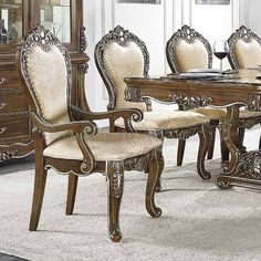 a dining room table with chairs and a china cabinet in the corner on carpeted flooring