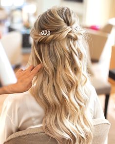 a woman is getting her hair done at the salon