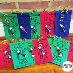 five little bags with markers on them are sitting on a table in front of a brick wall