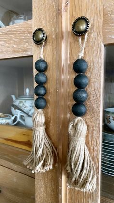 two black and white beads hanging from a wooden door