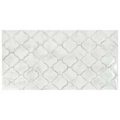 a white tile with an intricate pattern on it