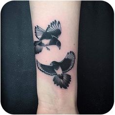 two black birds on the wrist tattoo