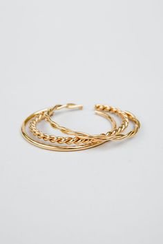 Introducing our stunning Neva cuff set, a playful and stylish addition to any jewelry collection. This set of stackable bracelets is expertly crafted from durable stainless steel and finished with a radiant 18k gold plating, creating a beautiful and eye-catching look.The Neva cuff set includes multiple bracelets that can be worn together for a bold and striking look or separately for a more subtle effect. The versatility of this set means that you can mix and match to create a variety of differe Trendy Stackable Yellow Gold Jewelry, Trendy Gold Stackable Jewelry, Trendy Stackable Gold Bangle, Trendy Gold Stackable Bangle, Trendy Stackable Gold-plated Jewelry, Adjustable Stackable Gold-plated Bangle, Stackable Gold Bangle Bracelet, Everyday Stackable Metal Bangle, Modern Twist Stackable Gold Jewelry