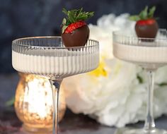 two glasses filled with chocolate covered strawberries