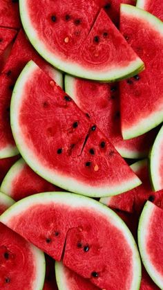 slices of watermelon are arranged on top of each other in a pile and ready to be eaten