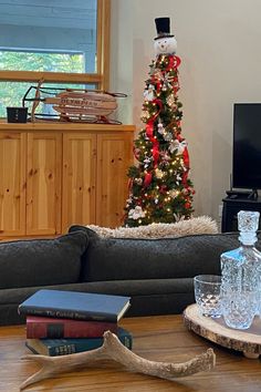 a living room filled with furniture and a christmas tree