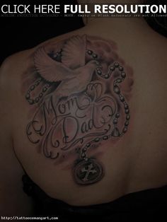 the back of a woman's shoulder with a rosary and dove