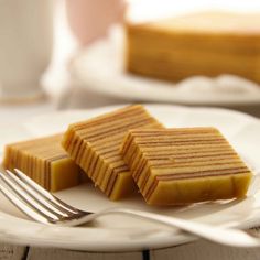 two slices of cake on a plate with a fork