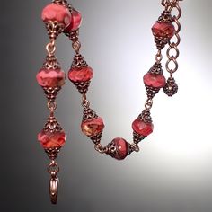 "This bracelet features artisan Czech glass rondelle beads adorned with antique-style filigree caps. These beads are a mix of opaque coral-colored glass and transparent peach glass with a metallic bronze finish on the edges. These beads are handmade in small batches and no two are alike. Dimensions and details: - Chain and filigree caps are antiqued copper-plated brass, lead-free and nickel-free - Beads are limited edition artisan Czech glass ----------------------------------------------------- Czech Glass Bead Bracelet, Czech Glass Jewelry, Glass Beaded Bracelets, Pretty Earrings, Denver Co, Czech Beads, Beaded Necklaces, Crystal Pearls, Czech Glass Beads