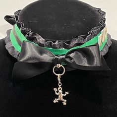 The Item Features A Black Ruffle Base With Green Middle Ribbon. There Is A Black Stripe With A Metallic Gold Trim On Its Edges In The Center. The Left Side Of The Choker Has A 3d “Ribbit” On Its Side. The Featured Charm Is A Silver Frog With Emerald Green Eyes. 1 Charm Included Per Purchase. All Charms Are On Clasp Which Allows Them To Be Attached And Detached At Will. They’re Fully Customizable! Please Check Out My Charm Selection Listing For All Available Items. Adjustable Black Choker For Costume Party, Adjustable Black Costume Jewelry, Adjustable Black Jewelry For Costume, Black Novelty Jewelry For Costume Party, Frog Necklace, Black Ruffle, Green Eyes, Gold Trim, Black Stripes