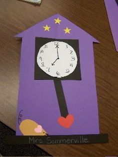 this is an image of a paper house with a clock on the front and side