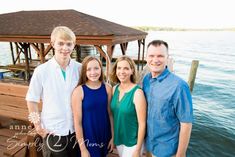 a family poses for a photo on the dock