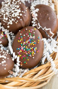 chocolate covered donuts with sprinkles in a basket