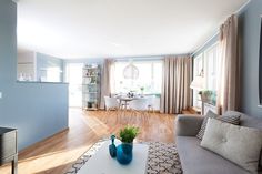 a living room filled with furniture and a flat screen tv on top of a hard wood floor