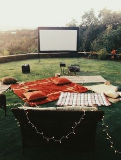 an outdoor movie is set up on the lawn