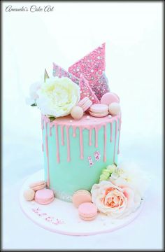 a pink and blue cake with flowers on top