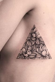 a black and white photo of a flowered triangle tattoo on the left side of a man's chest