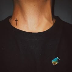 a man with a cross tattoo on his neck