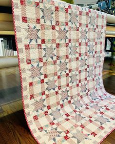 a large quilt is on display in a room