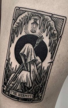 a black and white tattoo on the leg of a woman with a cross in her hand